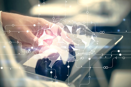 Double exposure of man's hand holding and using a digital device and brain hologram drawing. Data...