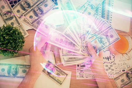 Multi exposure of Tech drawing hologram and USA dollars bills and man hands. Technology concept.の写真素材