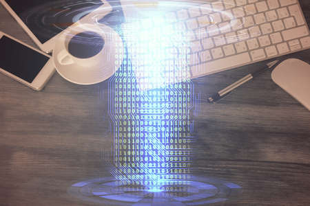 Double exposure of technology theme drawing over work table desktop. Top view. Global data analysis...