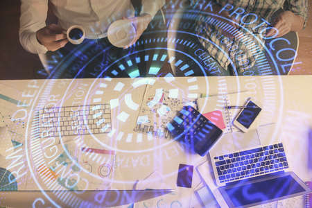 Double exposure of man and woman working together and data theme hologram drawing. Computer background. Top View.の写真素材