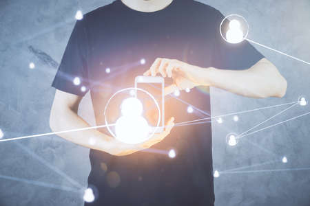 Double exposure of man's hands holding and using a phone and social network theme drawing.の写真素材