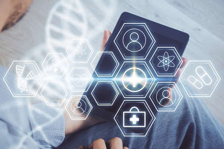 Double exposure of man's hands holding and using a phone and DNA drawing. Medical education concept.