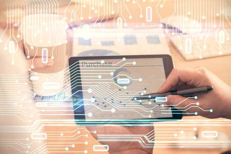Multi exposure of man's hands holding and using a digital device and data theme drawing. Innovation...