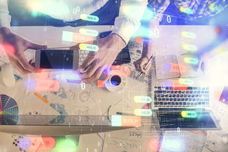 Double exposure of man and woman working together and data theme hologram drawing. Computer...