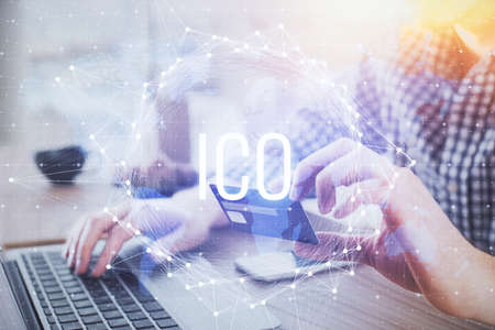 Double exposure of man hands holding a credit card and crypto business theme drawing. Digital...