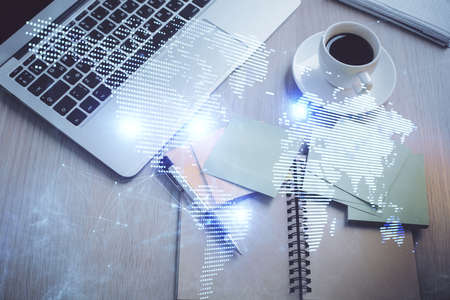 Social network hologram drawings over computer on the desktop background. Top view. Double exposure.