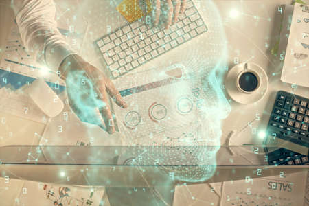 Double exposure of man's hands typing over computer keyboard and brain hologram drawing. Top view. Ai and data technology concept.の写真素材