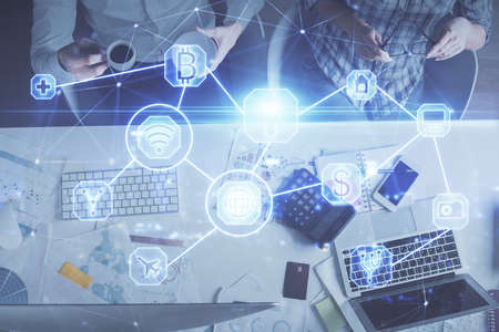 Double exposure of man and woman working together and social network theme hologram drawing....