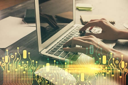 Double exposure of woman hands working on computer and data theme hologram drawing. Tech concept.