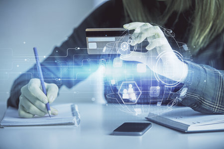 Multi exposure of woman on-line shopping holding a credit card and social network theme drawing....