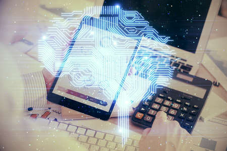 Double exposure of man's hand holding and using a digital device and brain hologram drawing. Data...