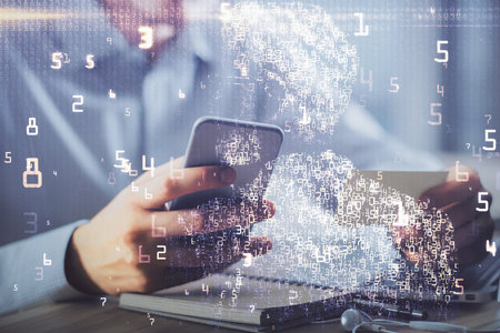 Double exposure of man's hands holding and using a digital device and tech theme hologram drawing....
