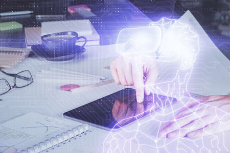 Double exposure of man's hands holding and using a digital device and AR glasses drawing. Virtual...