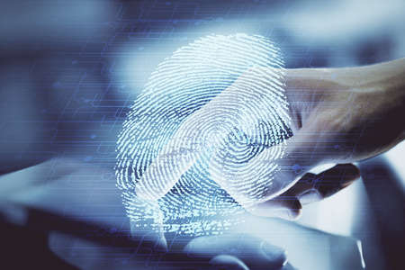 Double exposure of man's hands holding and using a digital device and fingerprint hologram drawing. Security concept.の写真素材