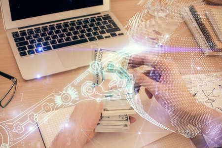 Multi exposure of Tech drawing hologram and USA dollars bills and man hands. Technology concept.