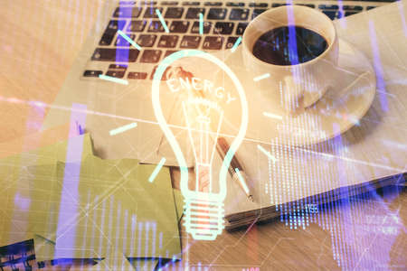 Double exposure of bulb drawing and desktop with coffee and items on table background. Concept of ideas.の写真素材