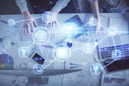Double exposure of man and woman working together and social network theme hologram drawing....