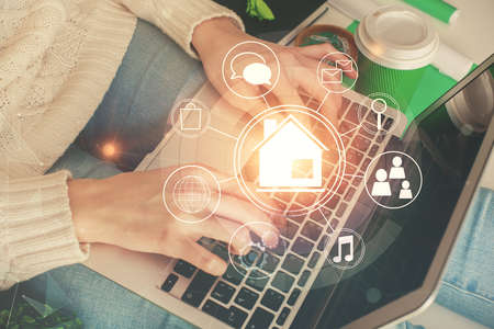 Double exposure of woman hands typing on computer and buildings drawing. Smart-city concept.
