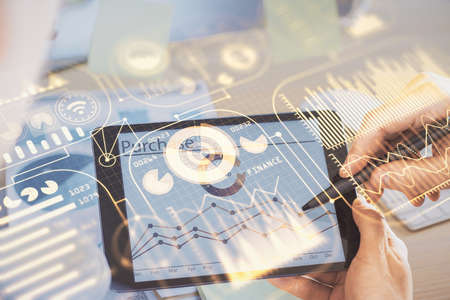 Double exposure of man's hands holding and using a digital device and tech theme hologram drawing. Technology concept.の写真素材