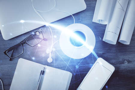 Social network hologram drawings over computer on the desktop background. Top view. Multi exposure. Concept of people connection.の写真素材
