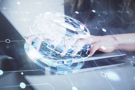 Double exposure of woman hands working on computer and data theme hologram drawing. Tech concept.