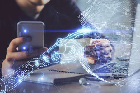 Double exposure of man's hands holding and using a digital device and tech theme hologram drawing....