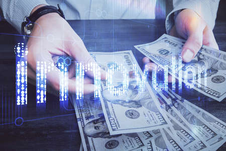 Double exposure of technology drawing hologram and us dollars bills and man hands. Data concept