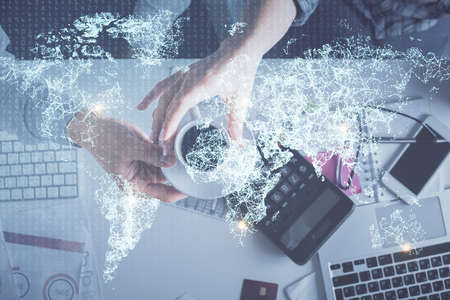 Double exposure of man and woman working together and social network theme hologram drawing. Computer background. connecting concept. Top View.の写真素材