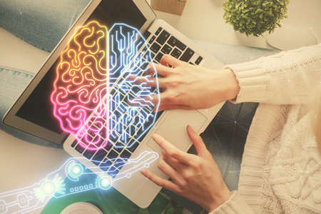 Double exposure of woman working on computer andhuman brain hologram drawing. Top View. Ai concept.
