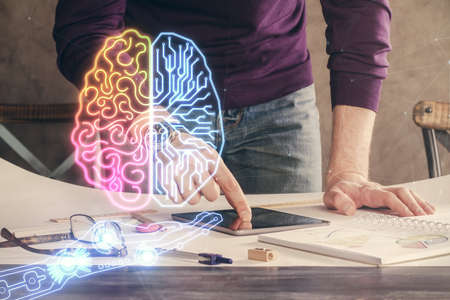 Double exposure of man's hand holding and using a digital device and brain hologram drawing. Data concept.の写真素材
