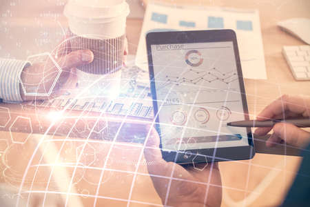 Multi exposure of man's hands holding and using a digital device and map drawing. International...