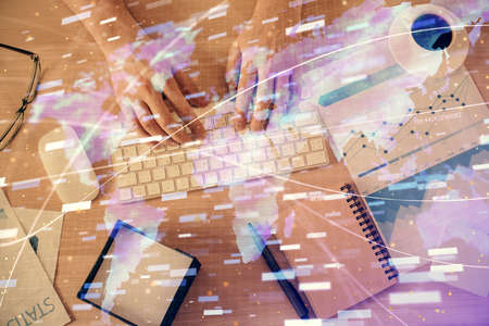 Double exposure of man's hands typing over computer keyboard and data theme hologram drawing. Top view. Technology concept.の写真素材