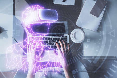Double exposure of woman hands working on computer and man in ar glasses hologram drawing. Top View....