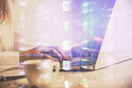 Multi exposure of woman hands working on computer and data theme hologram drawing. Tech concept.
