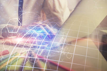 Double exposure of woman hands working on computer and world map hologram drawing. International...