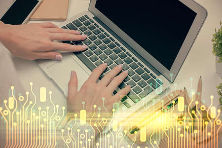 Double exposure of woman hands working on computer and data theme hologram drawing. Tech concept.
