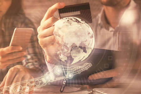 Double exposure of man and woman on-line shopping holding a credit card and map hologram drawing. International E-commerce pay on-line concept.の写真素材