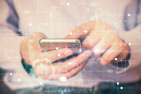 Multi exposure of man's hand holding and using a digital device and data theme drawing. Innovation...