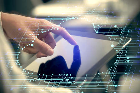 Multi exposure of man's hand holding and using a digital device and data theme drawing. Innovation...
