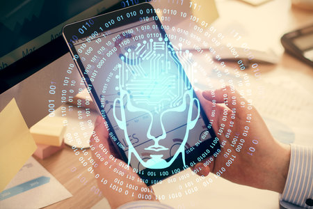 Double exposure of man's hand holding and using a digital device and brain hologram drawing. Data...