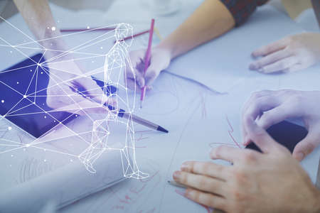 Double exposure of creative hologram drawing and man and woman working together holding and using a mobile device.の写真素材