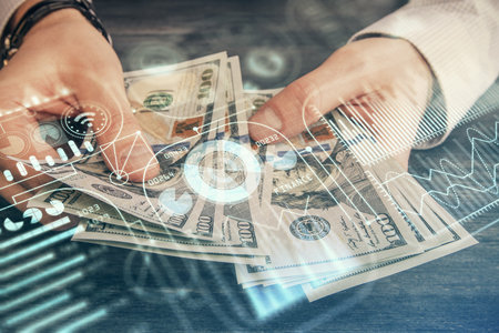 Multi exposure of Tech drawing hologram and USA dollars bills and man hands. Technology concept.の写真素材