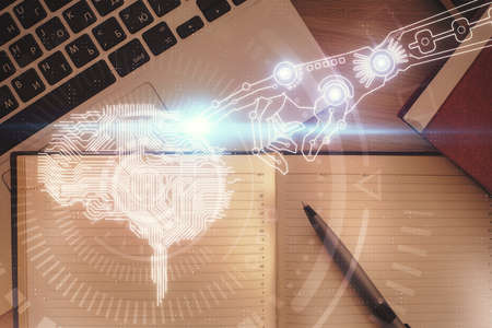 Double exposure of brain drawing hologram over topview work table background with computer. Concept...