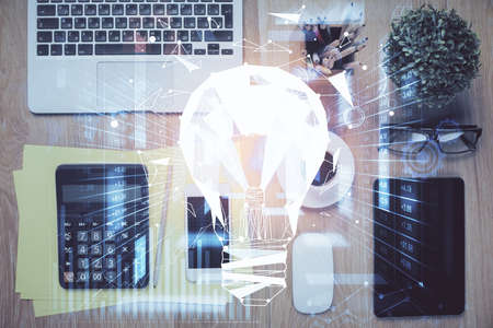 Double exposure of bulb drawing over table with phone. Top view. Concept of idea.の写真素材