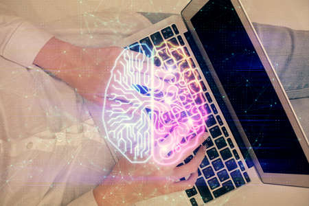 Double exposure of woman working on computer andhuman brain hologram drawing. Top View. Ai concept.の写真素材