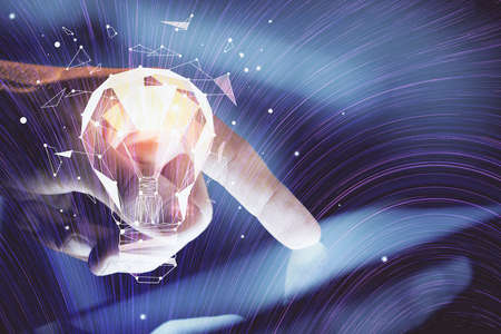 Double exposure of man's hands holding and using a digital device and bulb hologram drawing. Idea concept.の写真素材