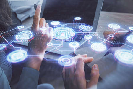 Double exposure of man and woman working together and social network theme hologram drawing. People...