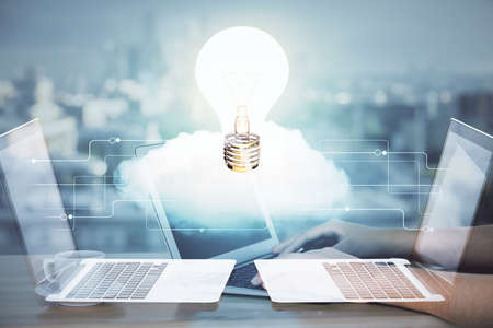 Double exposure of woman hands typing on computer and light bulb drawing. Idea concept.