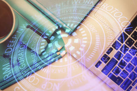 Multi exposure of data drawing hologram over topview of study desk background with computer. Concept...