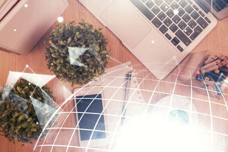 Double exposure of map hologram drawing over desktop. Top view. International connection concept.